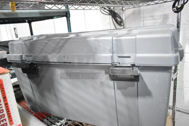 Gray poly tool box with secure latches, part of tier lot including Tru Rubber extension cord, on metal shelving.