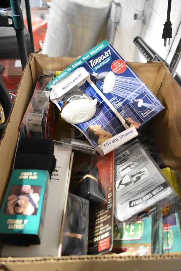 Box of assorted items including Tru rubber extension cord, gray poly tool box, and TurboJet showerhead. Various packaging shown.