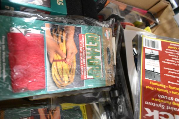 Tier lot including Tru Rubber extension cord, Get-A-Grip straps, and a gray poly tool box. Items appear new in packaging.