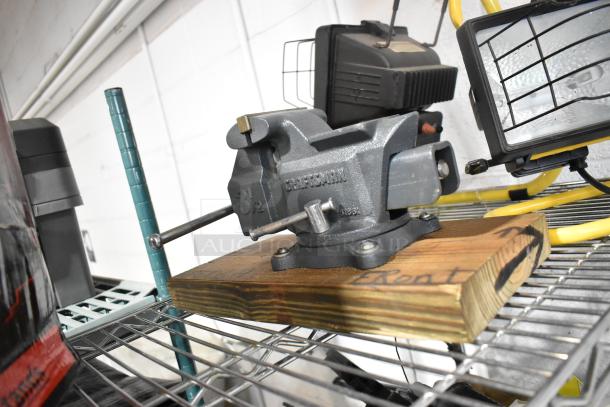 Auction lot with Craftsman 3 1/2" vise, SM2262 magnetic worklight, jack stands, and stretch net. Good condition.