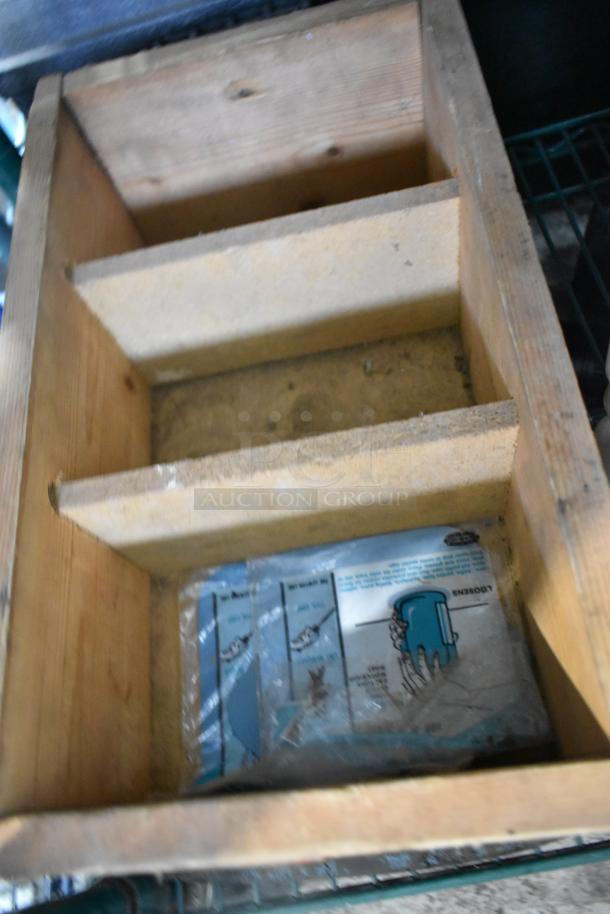 Wooden organizer containing various items, including EZ Handspreader, nails, and Sears Air Tool Lubricating Oil.