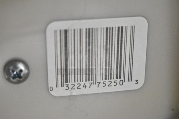 A barcode sticker with numbers "3224775250" on a light gray background near a metal screw.