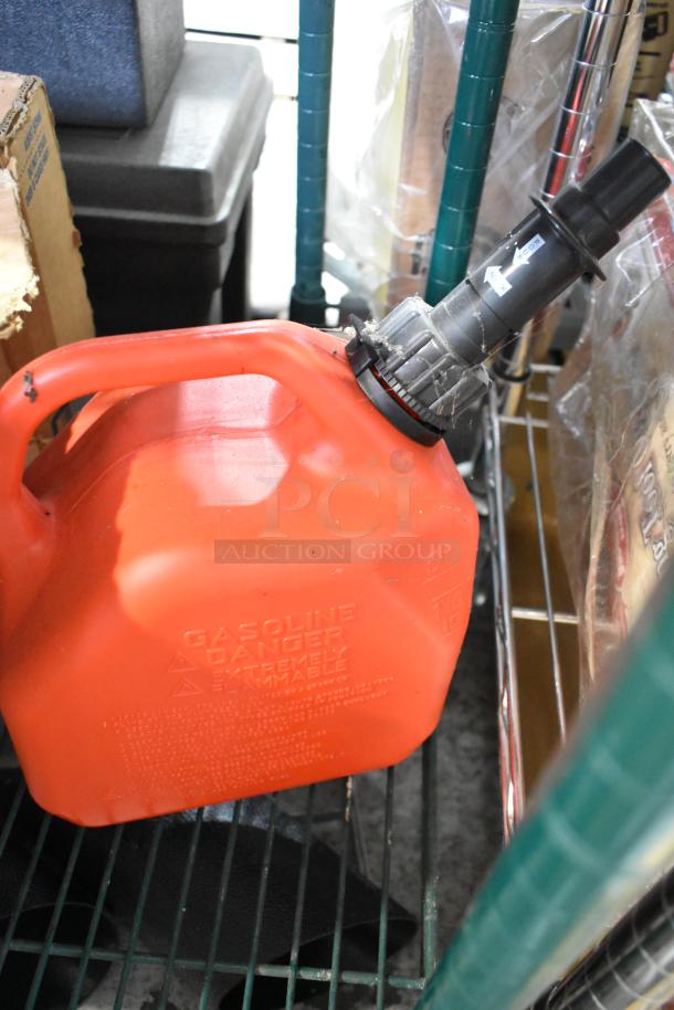 Red gasoline container with attached black spout, labeled "GASOLINE DANGER." Part of tier lot with various items.