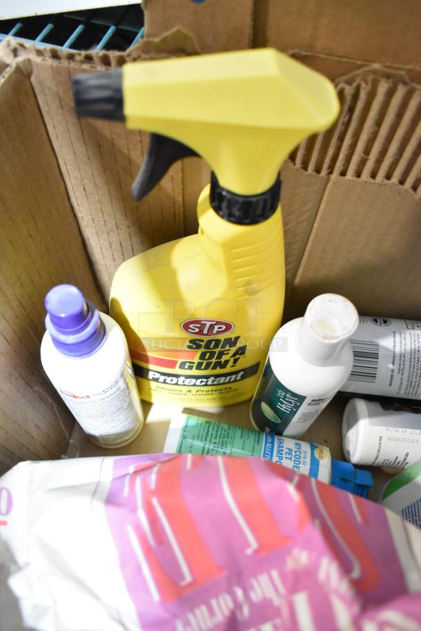 Box of assorted items including STP Son of a Gun protectant, Sears Air Tool Lubricating Oil, and other cleaning products.
