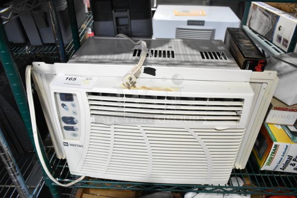 Maytag window mount air conditioner with control panel, on shelf with Sure Sak drum liners and keyed entry knobset. Visible label reads "165."