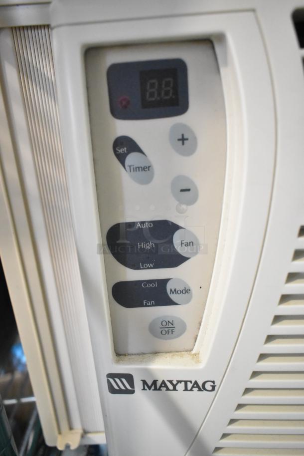 Maytag window mount air conditioner, white, digital controls, various settings. Visible logo and operational buttons.