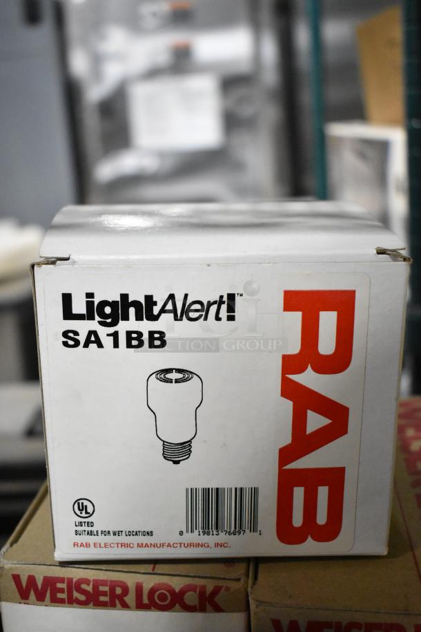 Box of RAB LightAlert SA1BB, suitable for wet locations, on top of Weiser Lock box. UL listed, barcode visible.