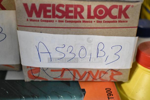 Weiser Lock box labeled "A530, B, 3," part of auction lot including Maytag AC, Sure Sak drum liners, knobset, brake fluid.