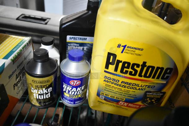 Tier lot including Prestone antifreeze, STP brake fluid, Weaver brake fluid, and SpectrumPlus oil, all for auction.
