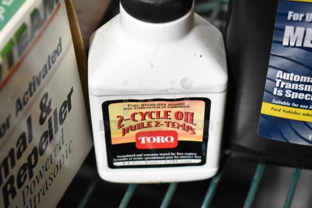Toro 2-Cycle Oil bottle with label indicating fuel stabilizer, part of a tier lot auction including various household items.