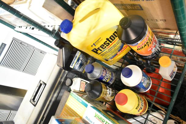 Tiered lot with Prestone antifreeze, Autoguard brake fluid, various automotive fluids, all in good condition.