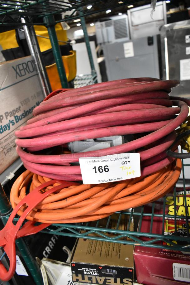 Tier lot with extension cords, labeled "166". Includes Security Plus System 1000 for alarm protection. Stored on a metal rack.