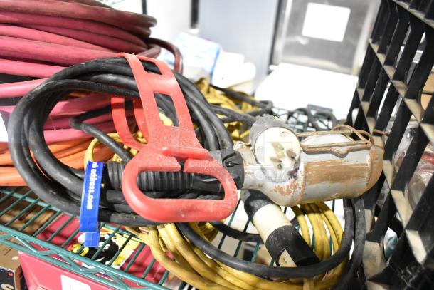 ALL ONE MONEY! Lot with extension cords, Security Plus System 1000 alarm, rugged condition, assorted cables visible.