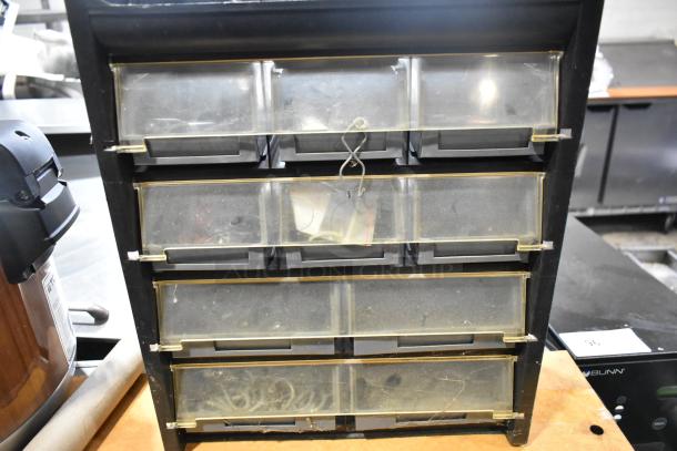 Poly Hardware Holder with clear bins, black frame, visible wear, suitable for organizing small parts and tools.