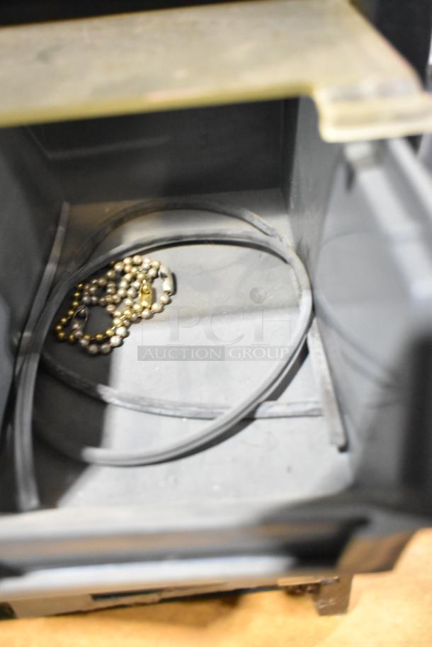 Poly hardware holder with bins containing metal chain and rubber bands. Features durable construction, ideal for organizing.