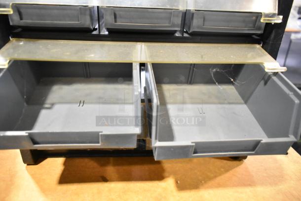 Poly hardware holder with multiple bins in good condition, features transparent dividers and robust gray plastic construction.