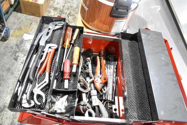 Red metal tool box with assorted tools, including pliers and screwdrivers, in good condition.