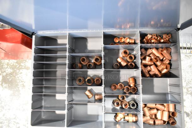Gray metal 4-drawer hardware box with various copper fittings organized in compartments. Excellent condition.