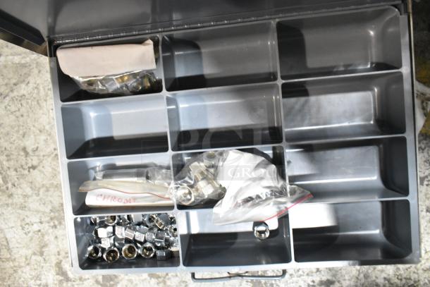 Gray metal 4-drawer hardware box with dividers, partially filled with labeled plastic bags of nuts and hardware.