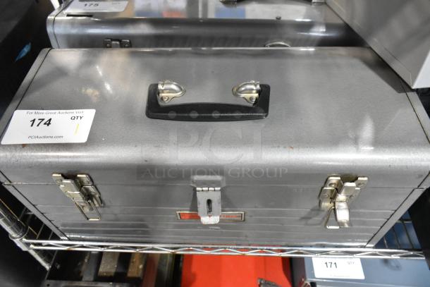 Craftsman gray metal toolbox, dual latches, sturdy handle, includes contents. Visible auction label "#174." Good condition.