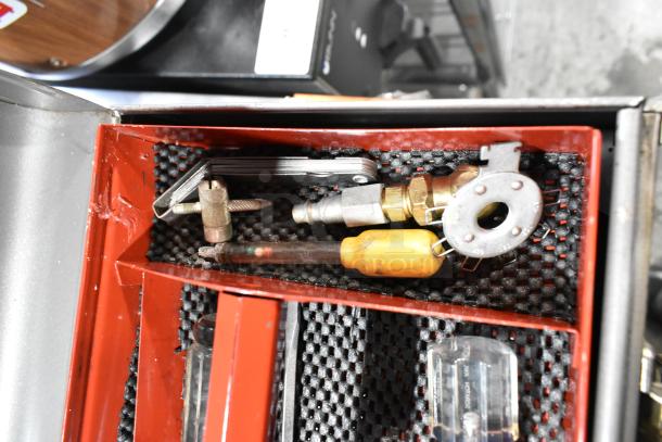 Craftsman gray metal tool box with assorted tools and fittings, featuring red interior compartments.