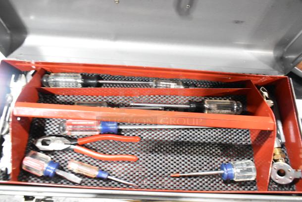 Craftsman gray metal tool box with assorted tools, including screwdrivers and pliers, lined interior, good condition.