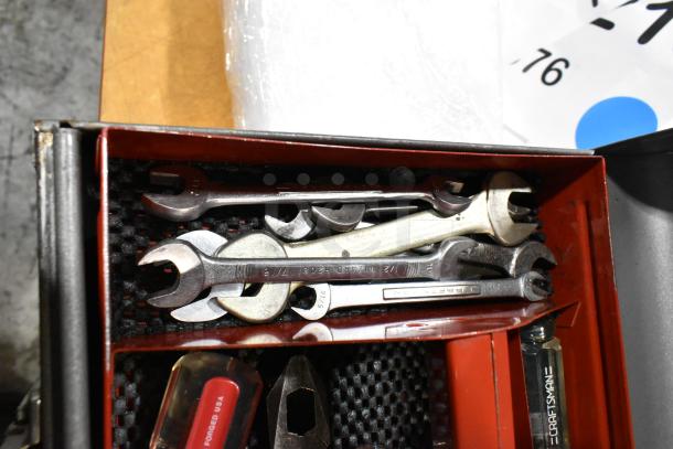 Craftsman gray metal tool box filled with mixed wrenches and tools, showing visible Craftsman branding. Tools in good condition.
