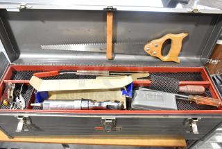 Craftsman gray metal tool box with various hand tools including a handsaw, screwdriver, and ratchet. Well-organized contents.