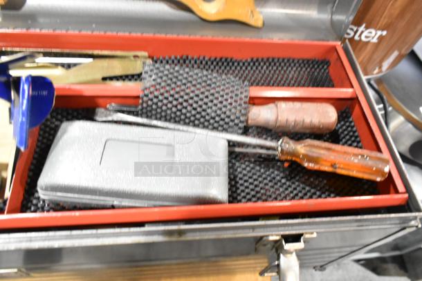 Craftsman gray metal tool box containing assorted tools including screwdrivers and a foam pad liner, visible wear.
