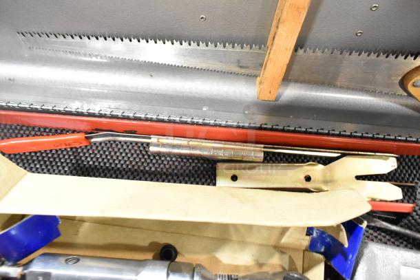 Craftsman gray metal tool box open with assorted tools inside, including saws, handled tools, and fasteners. Appears in good condition.