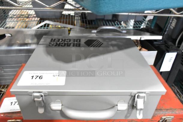 Black & Decker industrial electric power tool in gray metal toolbox with handle, marked with auction tag 176.