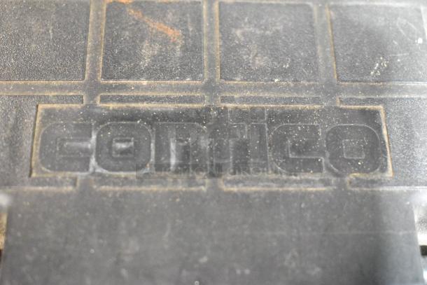 Contico black toolbox showing dust and signs of use, brand name embossed on lid. Contains assorted tools.