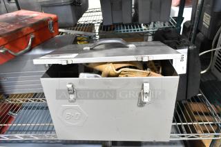 B&D gray metal box with contents, including a tool belt. Features secure clasps and durable handle, marked with B&D logo.