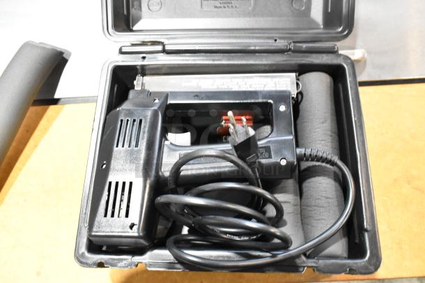 Craftsman electric power tool in a black poly tool box, includes power cord. Tool and box in used condition.