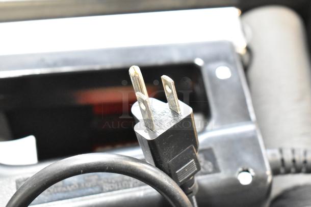 Craftsman electric power tool plug close-up in black poly tool box, indicating functionality and condition.
