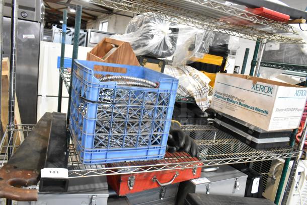 Mixed tier lot on metal shelving, including wires in a blue crate, black gloves, Xerox paper boxes, and various tools.