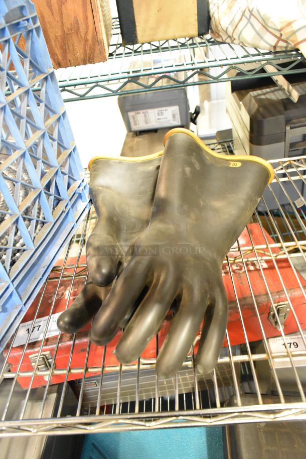 Alt text: Auction lot with large rubber gloves, plastic crate, wires, and poly boxes on metal shelf. Gloves size marked 10.