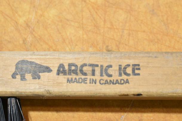 Arctic Ice tool handle with bear logo, "Made in Canada" marking, wooden construction.