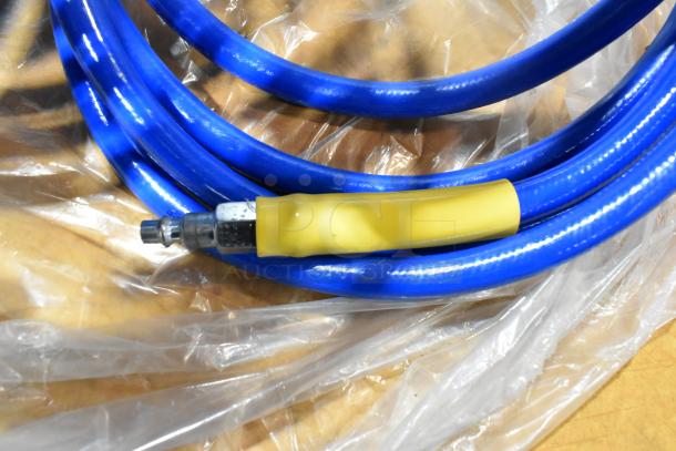 Blue hose with metal connector, yellow grip sleeve, coiled on clear plastic. Part of a mixed lot including tools and storage items.