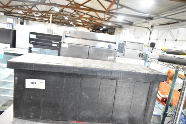 Gray poly tool box with contents, featuring a lid and secure latch. Auction tag 183 visible. Good condition.