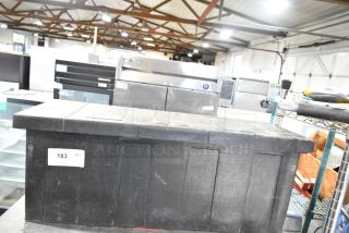 Gray poly tool box with contents, featuring a lid and secure latch. Auction tag 183 visible. Good condition.