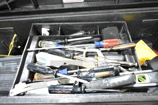 Gray poly tool box filled with assorted screwdrivers, pliers, and tools. Visible AMSCO USA marking on a screwdriver. Good condition.