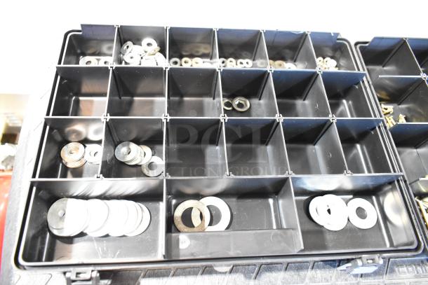 Black tool box with multiple compartments containing assorted metal washers, organized and in good condition.