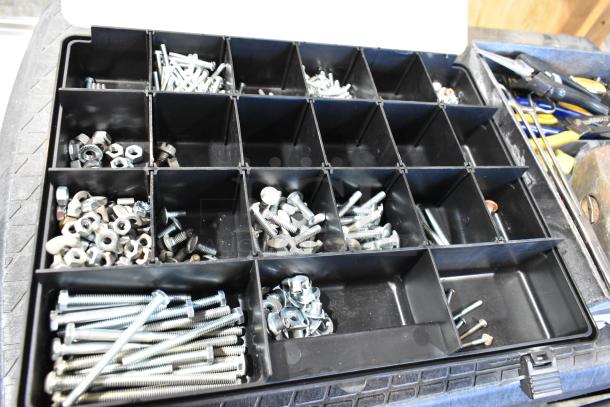 Black tool box with assorted screws, bolts, and nuts, organized in compartments. Sturdy case, ideal for workshop use.