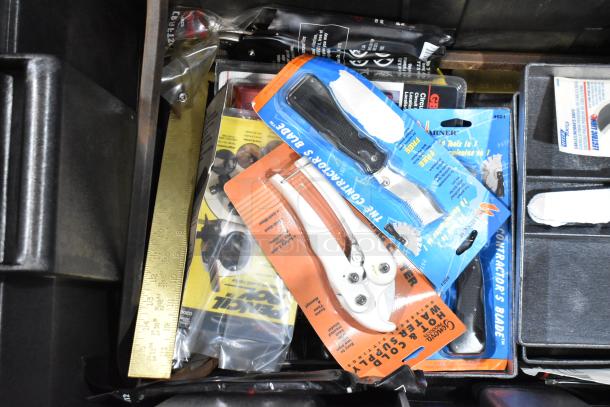 Toolbox with assorted tools in packaging, including a contractor's blade and pliers. Visible ruler and instructions.
