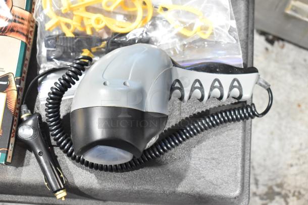 Pro Tuff Box Tool Box with assorted contents including a coiled cable device, yellow clips, and towels, in good condition.