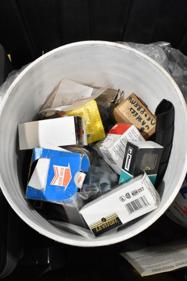 Pro Tuff Box tool box with various contents, including electrical boxes, packaging materials, and labeled items.