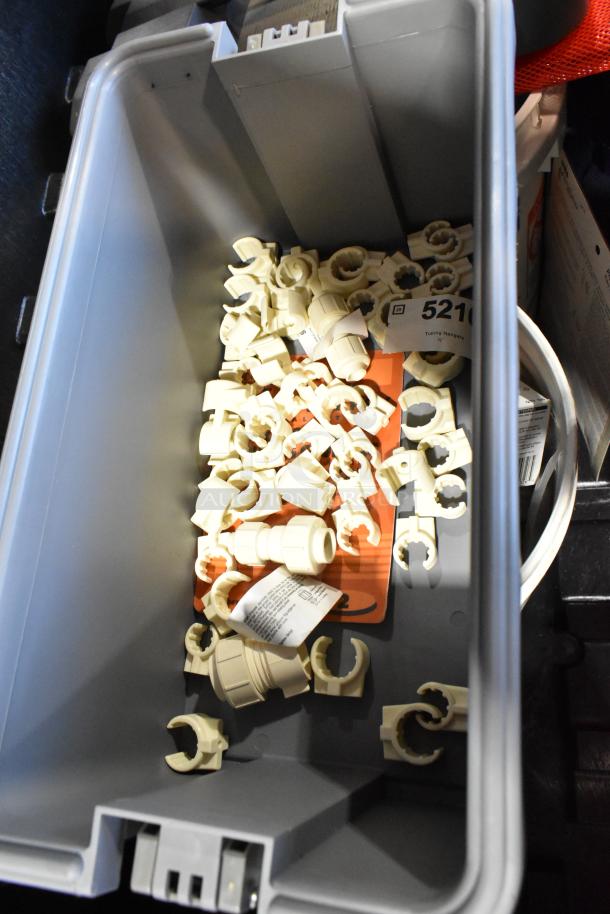 Pro Tuff Box Tool Box with plastic tubing hangers and assorted contents, including towels, in good condition.