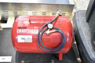 Craftsman 919-15209 air compressor, red, attached hose with pressure gauge, clean condition, visible brand label.