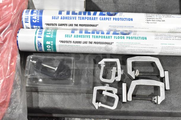 Trunk with contents including fire blanket, Film Tech carpet and floor protection rolls, and metal clamps. Good condition.